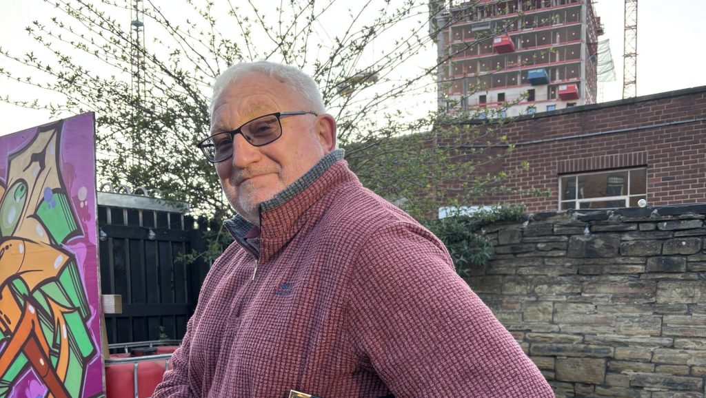 Graeme holding a 20th Anniversary Seagulls tote bag.